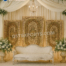 wedding reception stage backdrop, peacock theme wedding decor, golden wedding backdrop, floral wedding arch stage, luxury reception setup, engagement stage decoration, modern Indian wedding stage, bridal shower backdrop, couple seating decor, artificial flower arch, metal wedding backdrop, wedding photo booth frame, premium wedding decoration