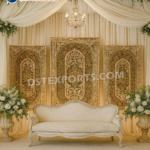 wedding reception stage backdrop, peacock theme wedding decor, golden wedding backdrop, floral wedding arch stage, luxury reception setup, engagement stage decoration, modern Indian wedding stage, bridal shower backdrop, couple seating decor, artificial flower arch, metal wedding backdrop, wedding photo booth frame, premium wedding decoration