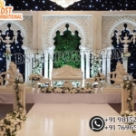 White 3D wedding stage backdrop ,English style wedding stage panels ,Luxury reception stage decor ,White arch wedding backdrop frames ,Indian wedding stage setup Australia ,Wedding stage decorations with Ganesha statues ,Indoor wedding stage ideas ,Elegant wedding backdrop panels Customizable wedding stage decor ,Modern white wedding stage design