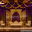 "Arabic theme golden open door style wedding stage backdrop with laser-cut panels, purple and gold drapery, royal sofa and chairs, and floral decorations – luxury wedding stage setup UK."