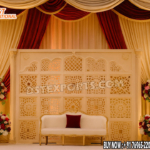 wedding reception stage backdrop, peacock theme wedding decor, golden wedding backdrop, floral wedding arch stage, luxury reception setup, engagement stage decoration, modern Indian wedding stage, bridal shower backdrop, couple seating decor, artificial flower arch, metal wedding backdrop, wedding photo booth frame, premium wedding decoration