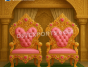 “Maharaja Style Bride and Groom Wedding Chairs – Golden carved wooden thrones with pink fabric tufted upholstery, designed for royal wedding stage seating.”