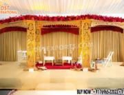 "Royal Gujarati Wedding Mandap with intricately carved wooden Ganesha pillars, golden finish, floral canopy, and stage setup for traditional Hindu ceremonies in USA."