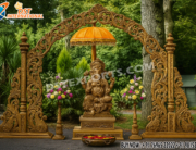 Royal Wooden Carved Ganesha Entrance Gate Decoration with intricate floral carvings, central Ganesha statue under a golden umbrella, flower stands on both sides, perfect for wedding or cultural event entrance decor.