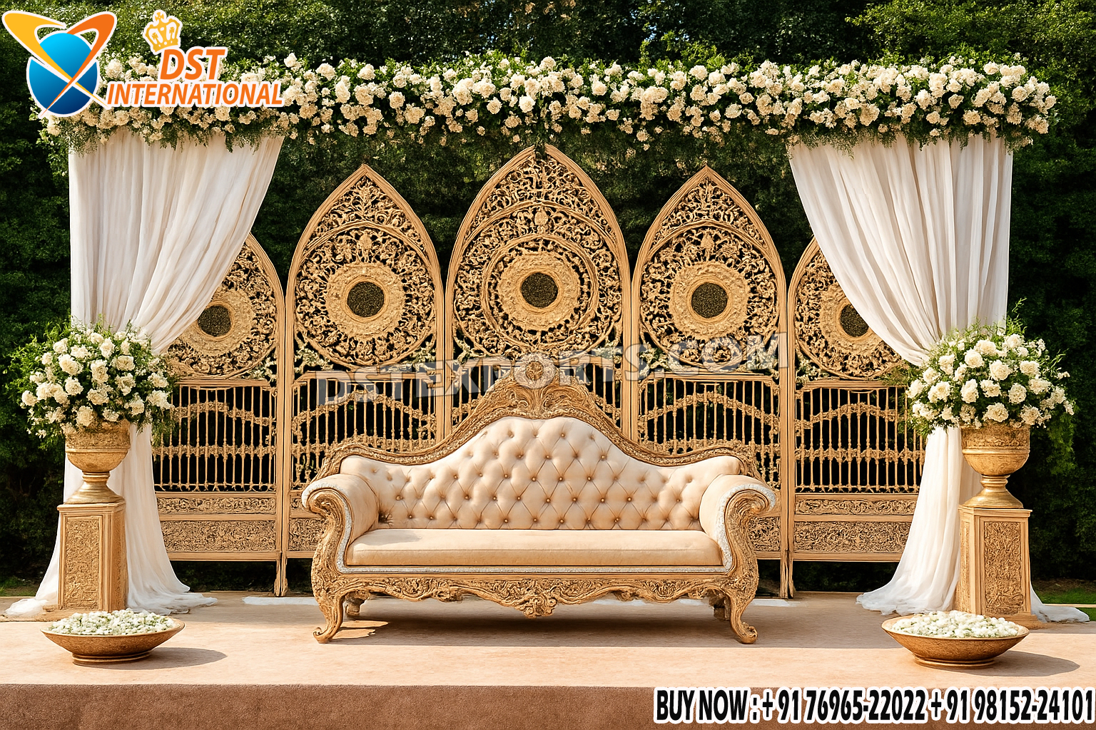 “Trending Designer Wedding Stage with golden carved metal backdrop frames, luxury sofa, white floral decorations, and elegant drapes – perfect for wedding and reception décor.”