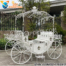 White metal Cinderella carriage selfie booth with decorative scrollwork and elegant design, perfect for wedding photography and fairytale event décor.