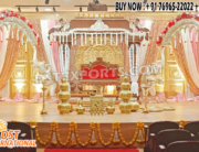 Grand Southern wedding stage setup with golden mandap, white elephant arch pillars decorated with flowers, and pink-golden drapes — perfect for traditional South Indian marriage ceremonies.