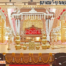 Grand Southern wedding stage setup with golden mandap, white elephant arch pillars decorated with flowers, and pink-golden drapes — perfect for traditional South Indian marriage ceremonies.