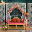 Modern geometric white laser-cut panels used as a wedding and event backdrop with floral decorations, yellow bench seating, and elegant stage decor by DST International.