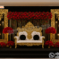 Royal golden fiber backdrop frames with ornate floral carving and luxury wedding reception stage setup with red floral arrangements and throne sofa.