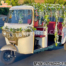 “Trending Mehendi Function Auto Rickshaw Photo Booth decorated with floral garlands, vibrant seating, and festive vines – perfect for Indian wedding celebrations and quirky Mehendi décor.”