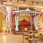 Grand Southern wedding stage setup with golden mandap, white elephant arch pillars decorated with flowers, and pink-golden drapes — perfect for traditional South Indian marriage ceremonies.